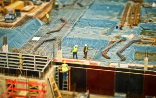 an aerial view of workers on a building construction site