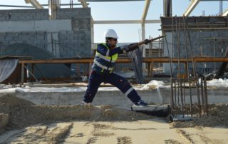 a construction worker pulling on rebar on a construction site