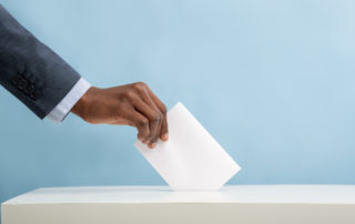 African american man putting an empty ballot in election box